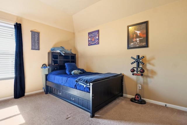 carpeted bedroom with lofted ceiling