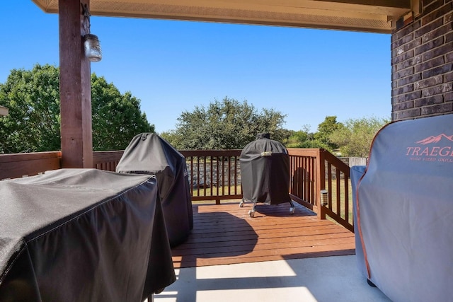 wooden deck featuring a grill