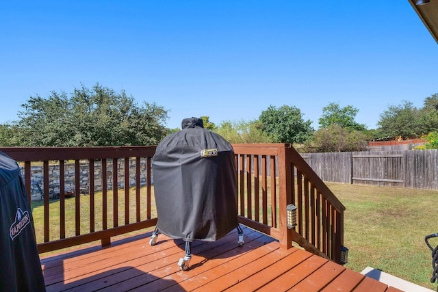 wooden terrace with a grill and a yard