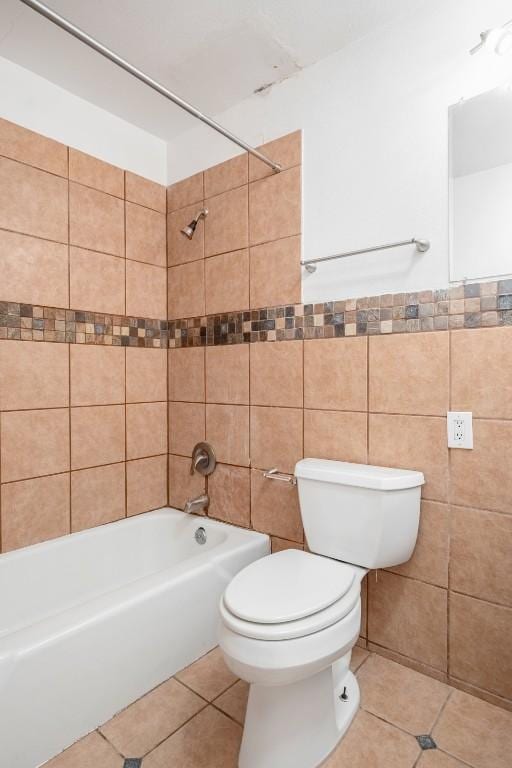 full bath featuring tile patterned floors, tub / shower combination, tile walls, and toilet
