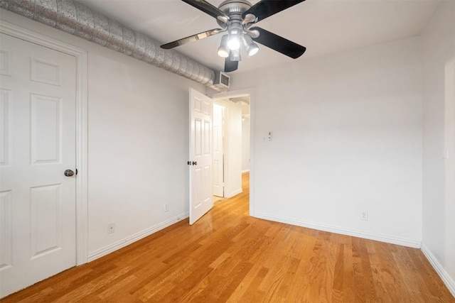 unfurnished bedroom with baseboards, light wood-type flooring, and a ceiling fan