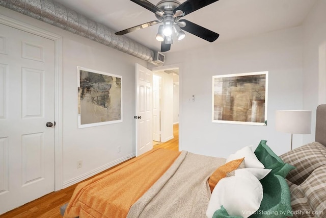 bedroom featuring wood finished floors and a ceiling fan