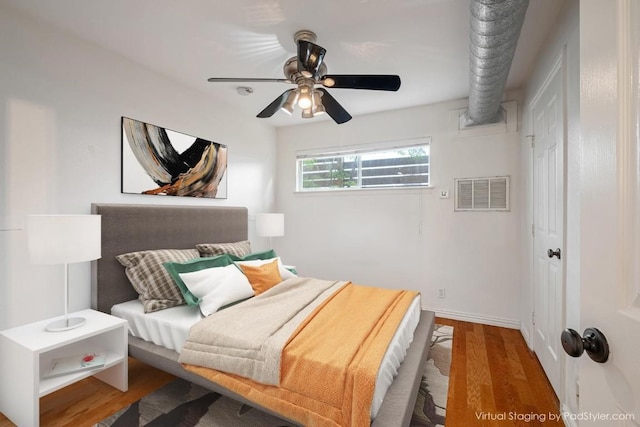 bedroom featuring wood finished floors, baseboards, and ceiling fan