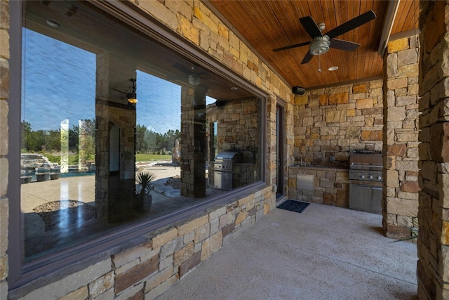 view of patio with ceiling fan, grilling area, and an outdoor kitchen