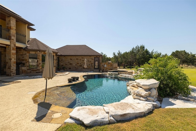 view of swimming pool featuring an in ground hot tub and a patio