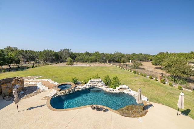 view of swimming pool featuring a lawn, a patio area, a rural view, and an in ground hot tub