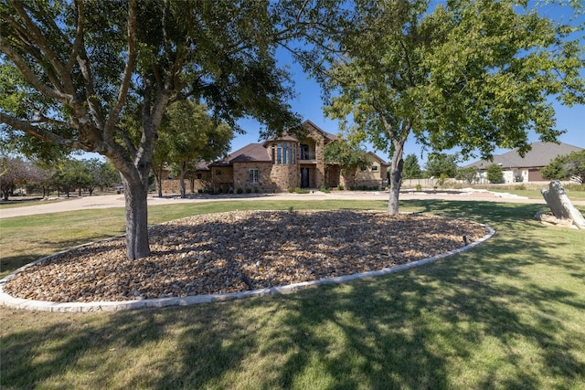 view of front of house with stone siding and a front yard