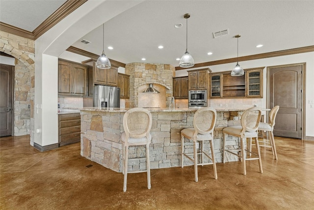 kitchen featuring glass insert cabinets, a spacious island, appliances with stainless steel finishes, and pendant lighting