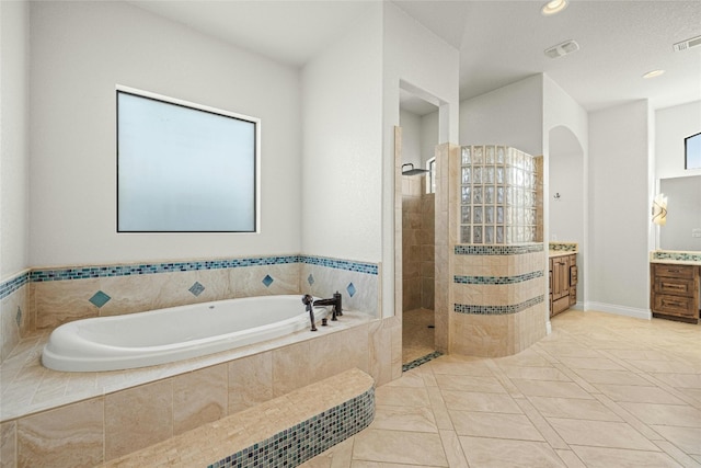 bathroom with a garden tub, recessed lighting, visible vents, vanity, and walk in shower