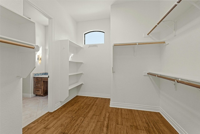 spacious closet with wood finished floors