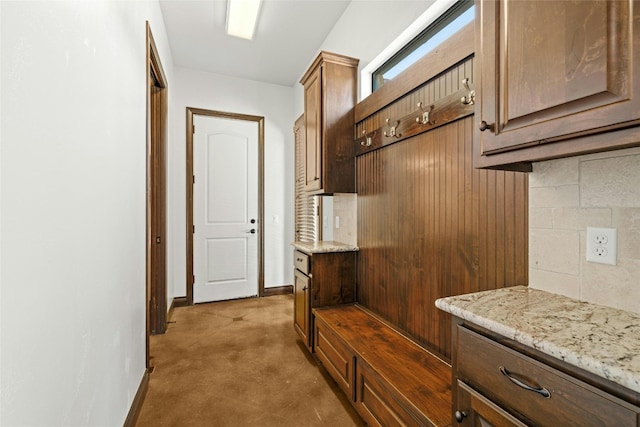 mudroom featuring concrete floors and baseboards