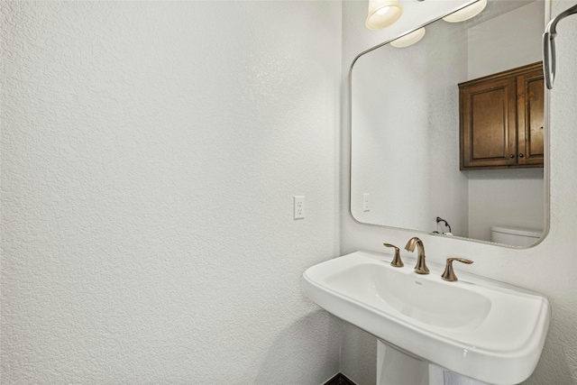 bathroom featuring a sink and toilet