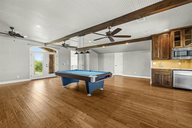 game room with french doors, dark wood-type flooring, sink, beam ceiling, and billiards