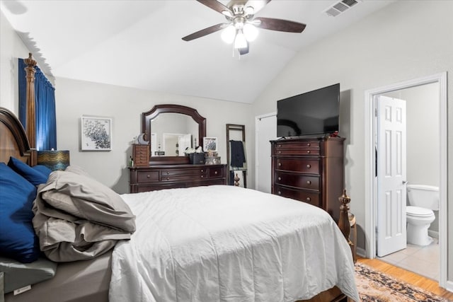 bedroom featuring lofted ceiling, connected bathroom, light hardwood / wood-style flooring, and ceiling fan