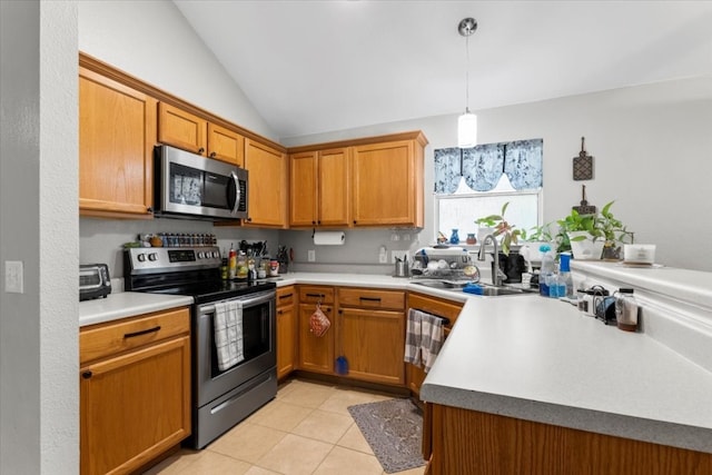 kitchen featuring sink, pendant lighting, vaulted ceiling, appliances with stainless steel finishes, and light tile patterned floors