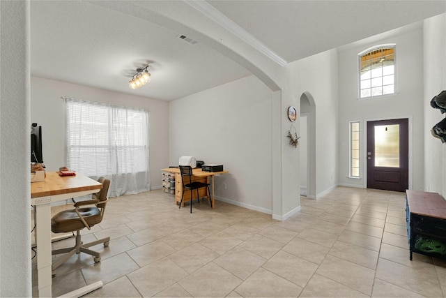 foyer with light tile patterned floors and a textured ceiling