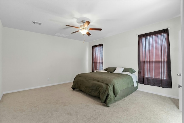 bedroom with ceiling fan and light colored carpet