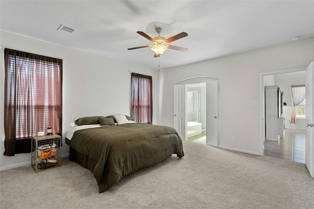 carpeted bedroom with ceiling fan and connected bathroom