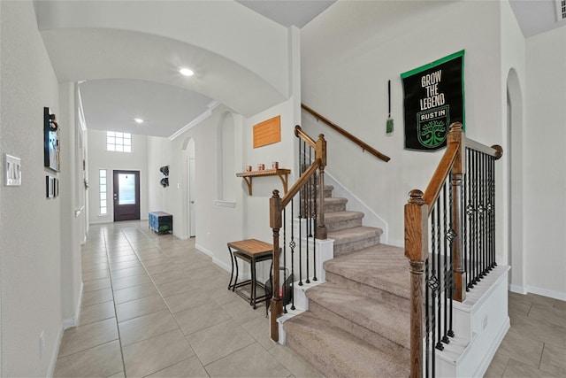 foyer entrance featuring ornamental molding and light tile patterned floors