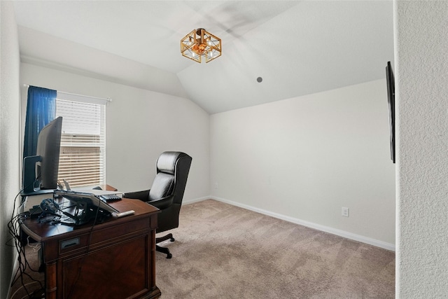 carpeted office featuring lofted ceiling