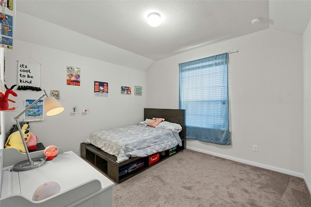 bedroom featuring lofted ceiling, carpet floors, and a textured ceiling