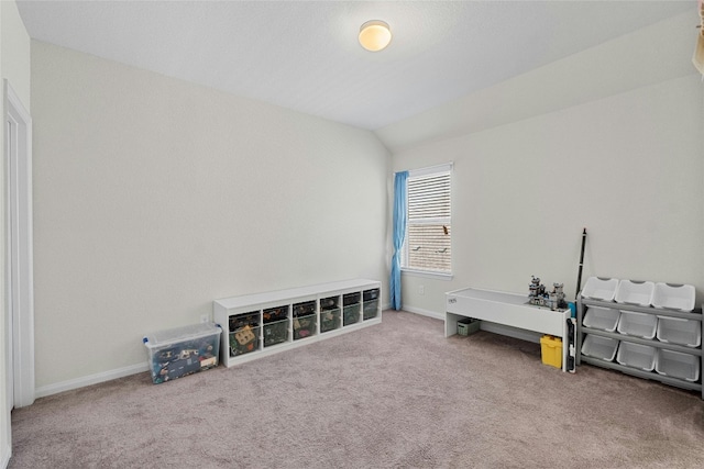 miscellaneous room with lofted ceiling and carpet floors