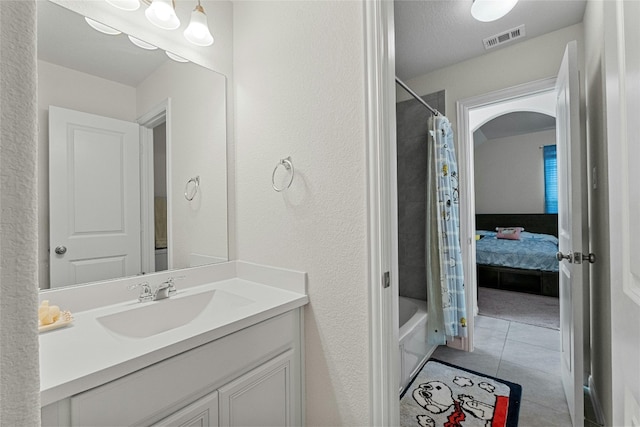 bathroom with shower / tub combo, tile patterned floors, and vanity