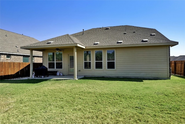 rear view of property featuring a patio area, a lawn, and ceiling fan