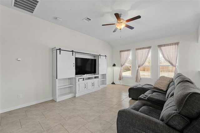 living room with ceiling fan, light tile patterned flooring, lofted ceiling, built in features, and a barn door