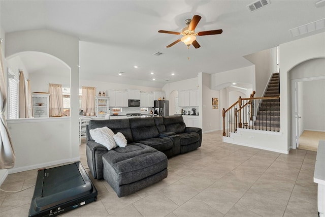 tiled living room with ceiling fan