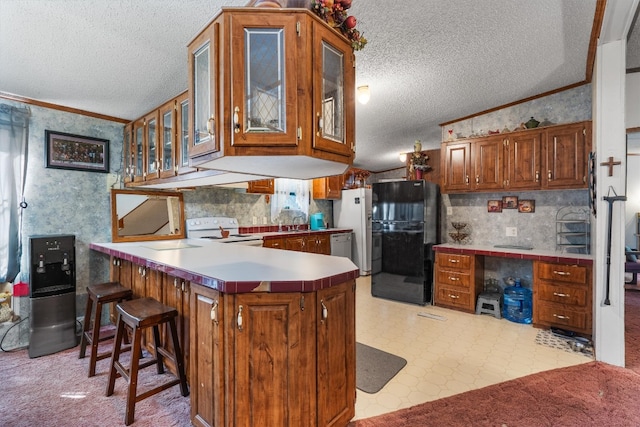 kitchen featuring white electric range oven, kitchen peninsula, black refrigerator, and a textured ceiling