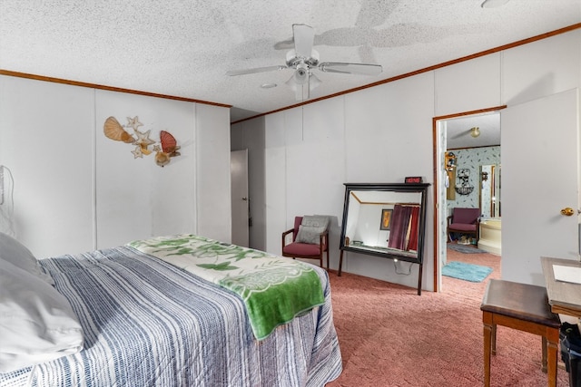 carpeted bedroom featuring ceiling fan, ensuite bathroom, ornamental molding, and a textured ceiling