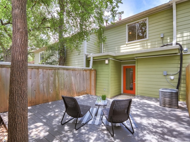 exterior space featuring a wooden deck and central AC