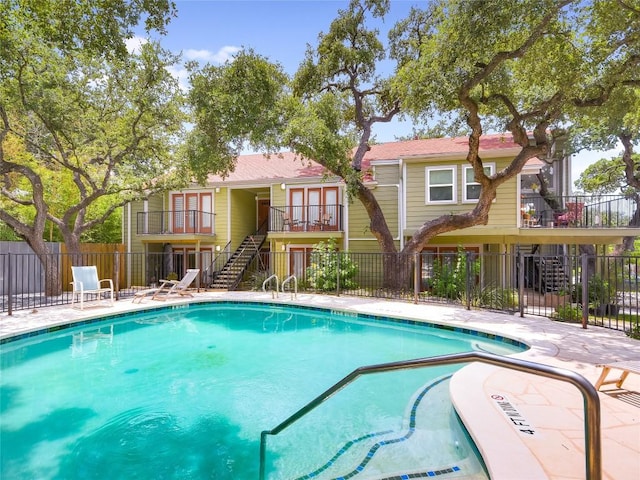 3601 Menchaca Rd Unit 109, Austin, TX 78704 - community pool with stairs, a patio area, and fence