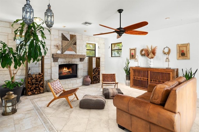 living room featuring visible vents, a fireplace, and ceiling fan