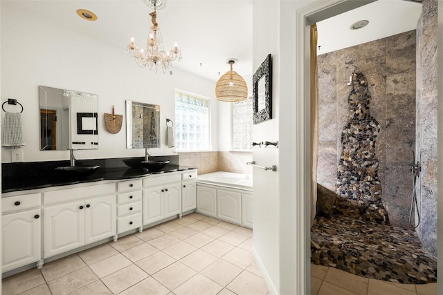 full bath featuring double vanity, a sink, a bath, and tile patterned floors