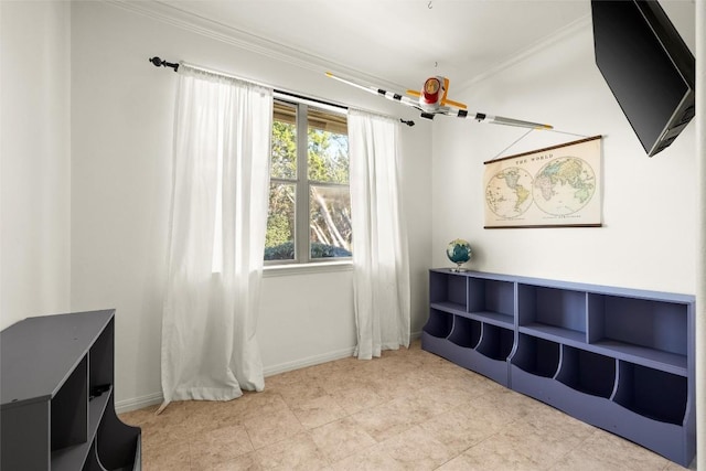 interior space featuring light tile patterned floors, baseboards, and ornamental molding