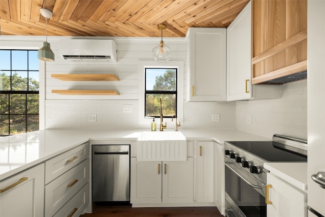 kitchen featuring a wall unit AC, stainless steel electric stove, white cabinets, and pendant lighting