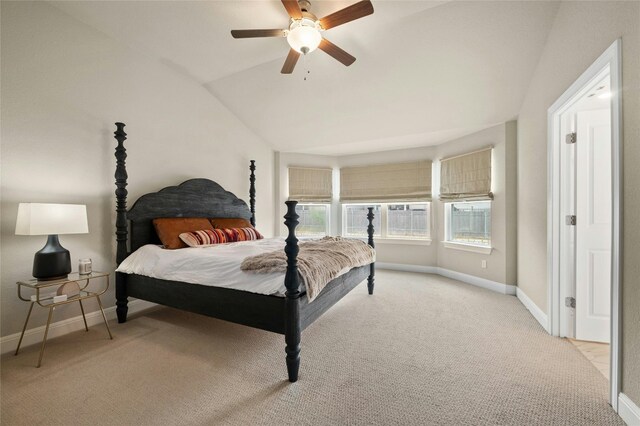 bedroom with lofted ceiling, light colored carpet, ceiling fan, and baseboards