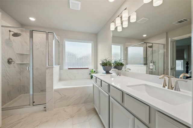 bathroom featuring visible vents, a sink, a marble finish shower, and a bath