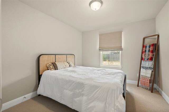 bedroom featuring carpet and baseboards