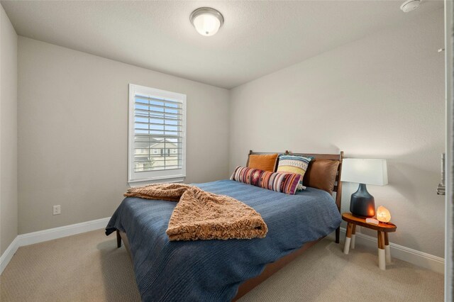 carpeted bedroom with baseboards