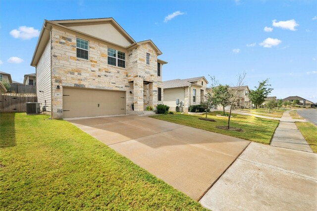 traditional home featuring an attached garage, stone siding, concrete driveway, and a front yard