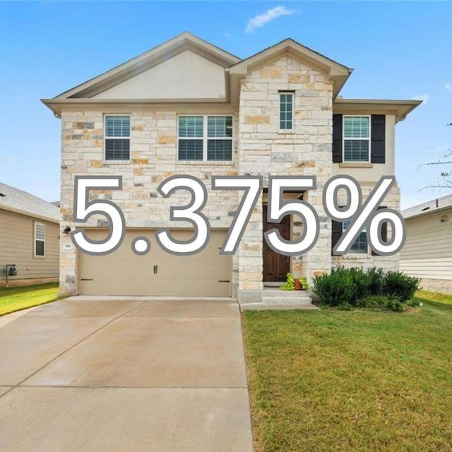 view of front of home featuring a garage, driveway, and a front yard