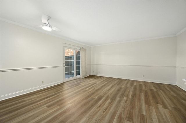 spare room featuring dark wood-type flooring, ornamental molding, and ceiling fan