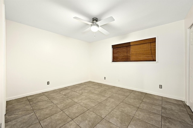 tiled spare room featuring ceiling fan