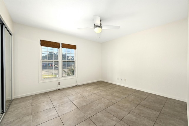 spare room featuring tile patterned flooring and ceiling fan