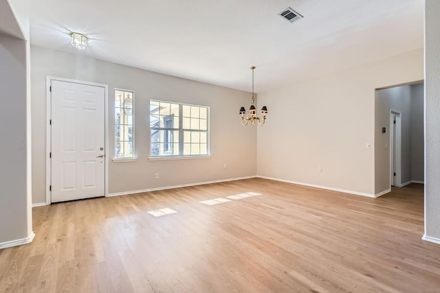 foyer featuring light hardwood / wood-style floors and a notable chandelier