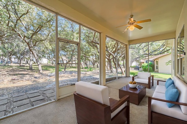 sunroom / solarium featuring ceiling fan