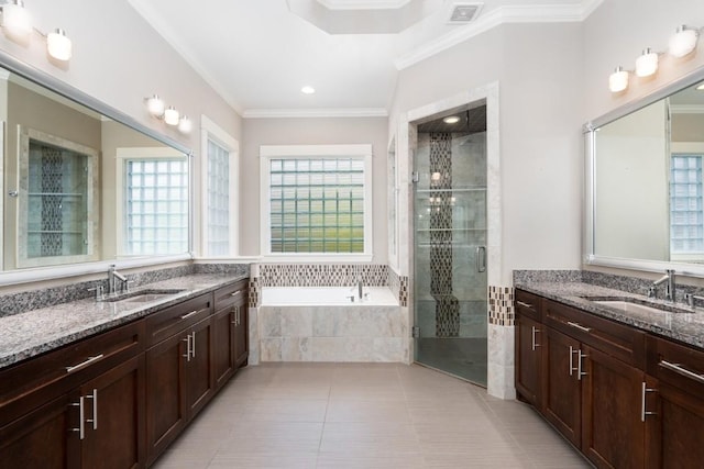 full bath with ornamental molding, plenty of natural light, and a sink